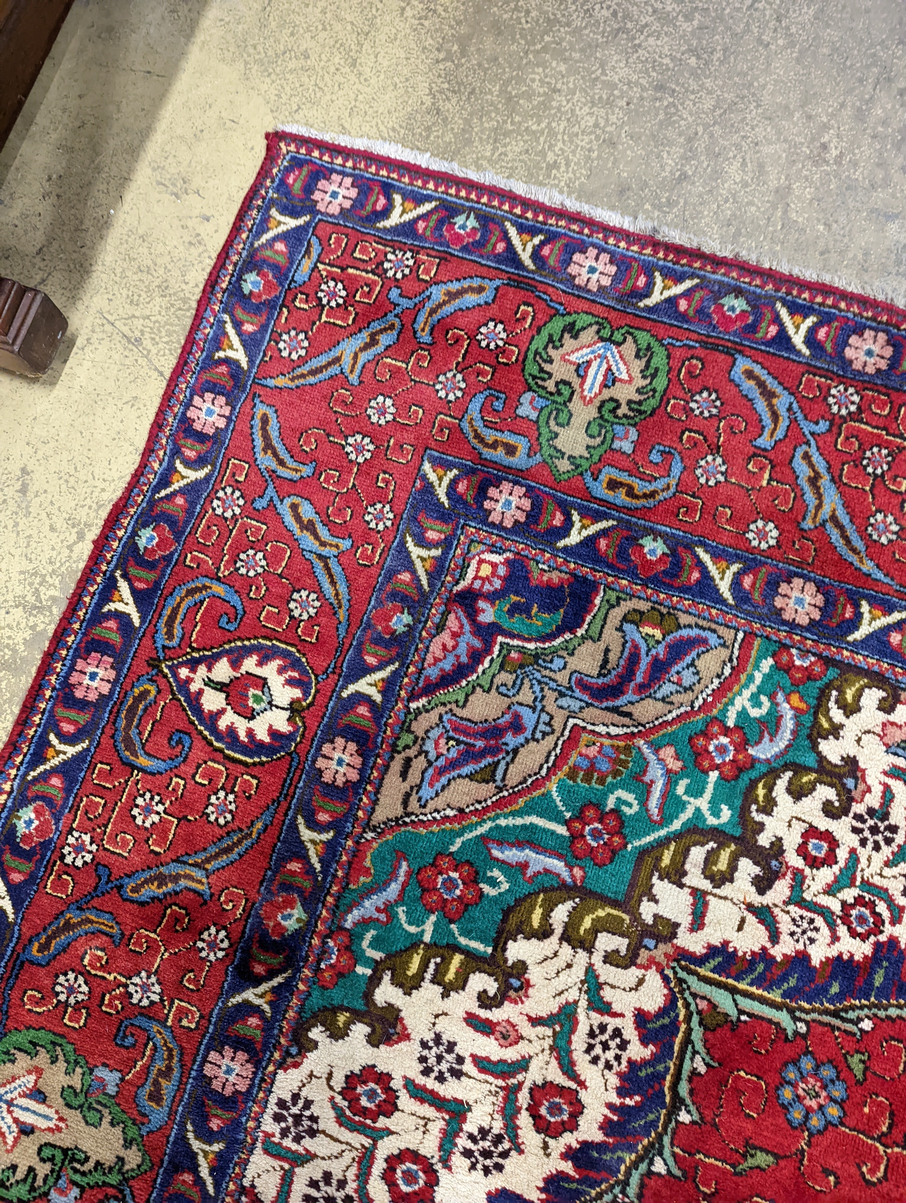 A Tabriz red ground carpet, 380 x 300cm